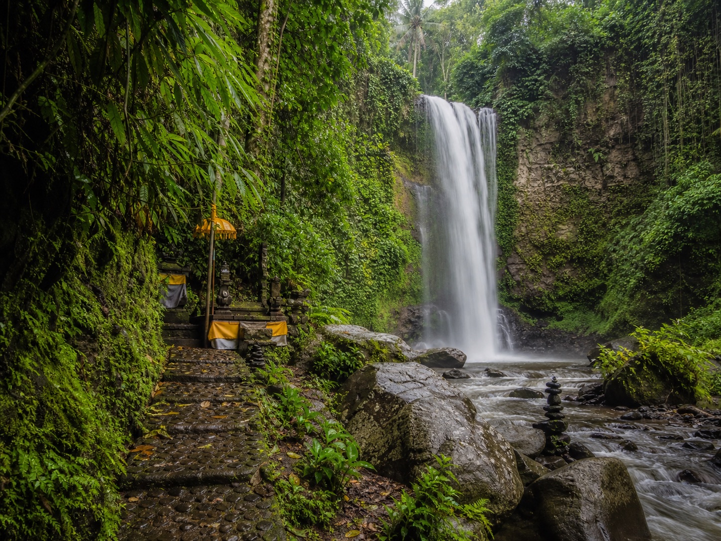 Tropical waterfall and Balinese shrine near Ubud